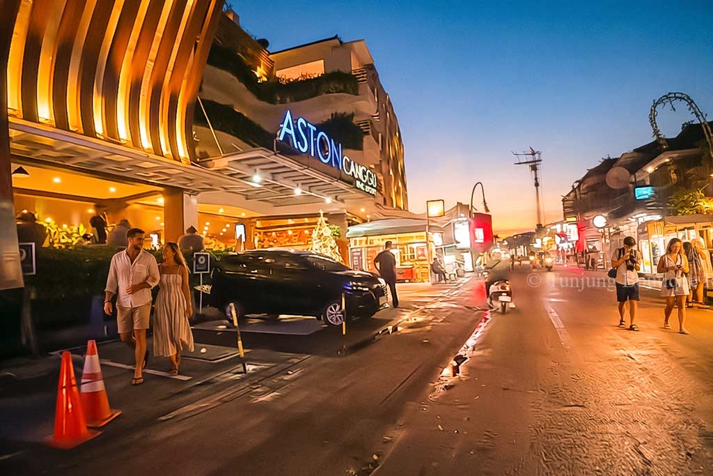 Canggu night streets around Batu Bolong Beach shining with vibrant restaurant and retail shop lighting.