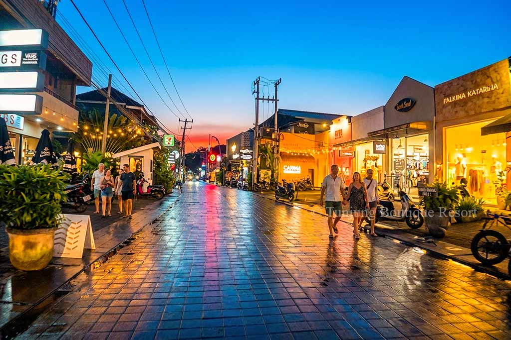 Canggu night streets after sunset filled with sparkling lights from roadside restaurants and boutique shops.